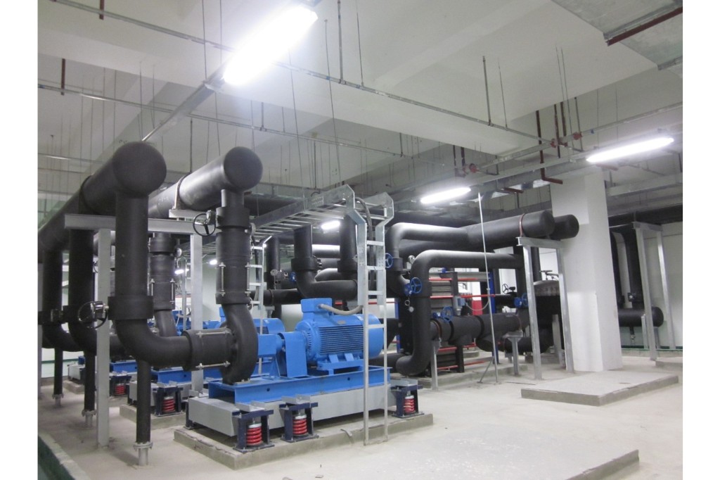 商业建筑 HVAC 系统：机房内循环水泵、黑色保温冷热水干管与阀门